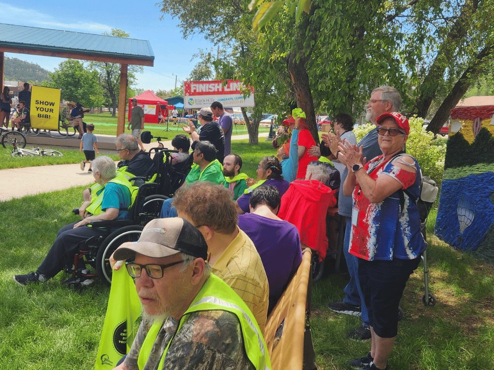 People gathered at the finish line to cheer for participants of a race.