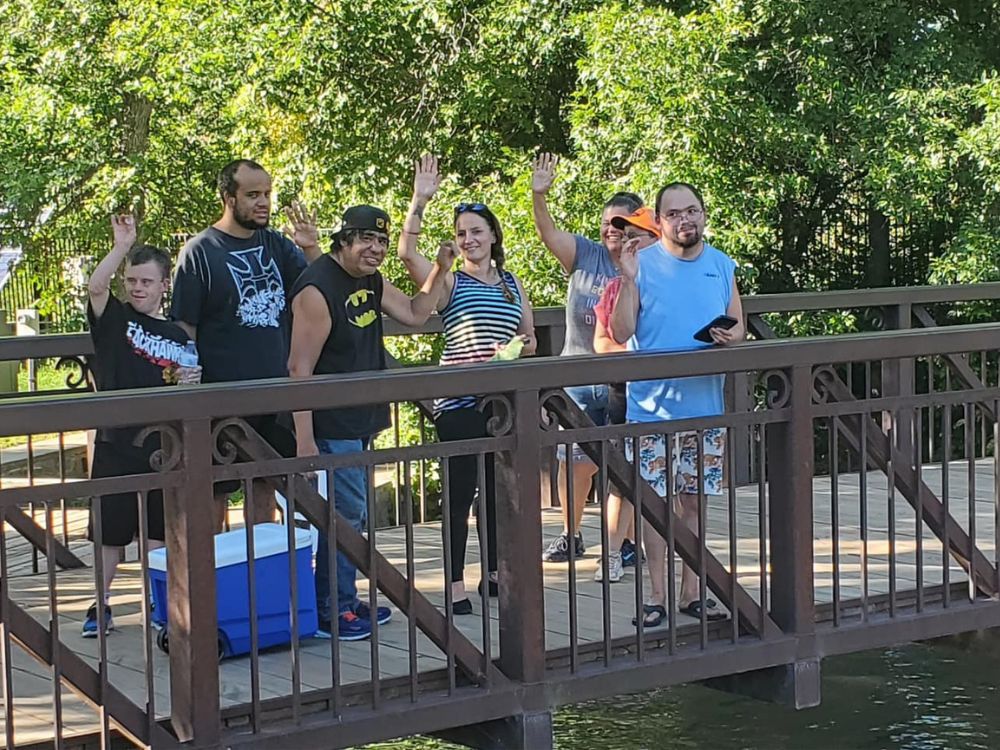 A group of people stands on a bridge