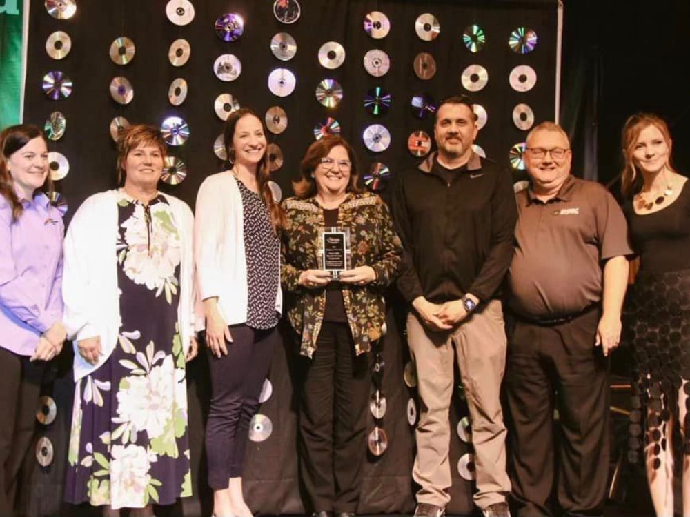 A group of BHSSC staff gathered on stage to receive the employer of the year award