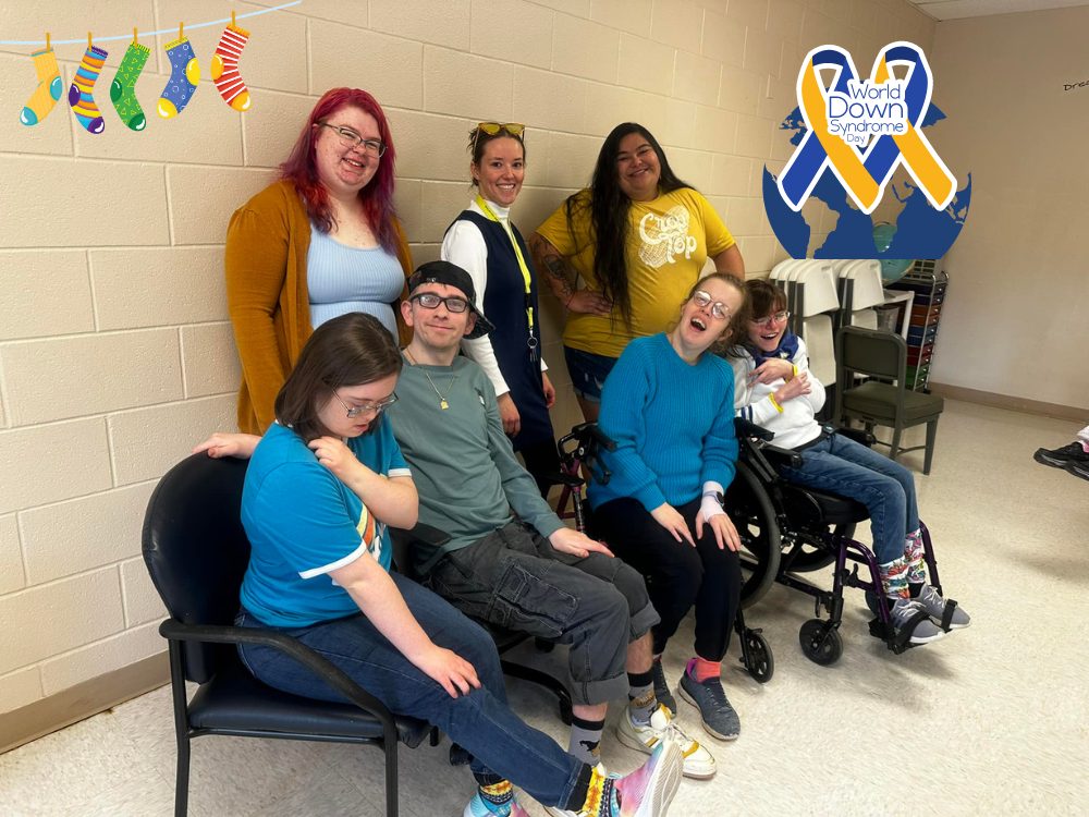 A group of staff and people supported showing different patterned socks to celebrate World Down Syndrome Awareness Day.